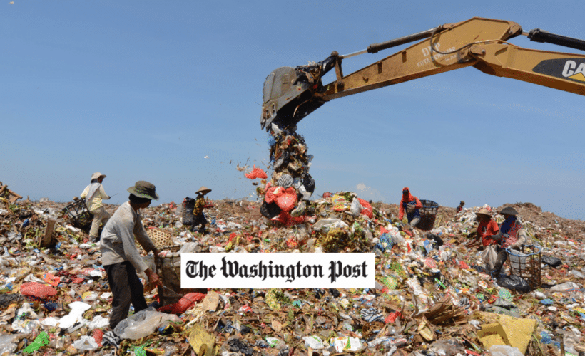 a crane in a large trash pile, Washington Post logo in foreground