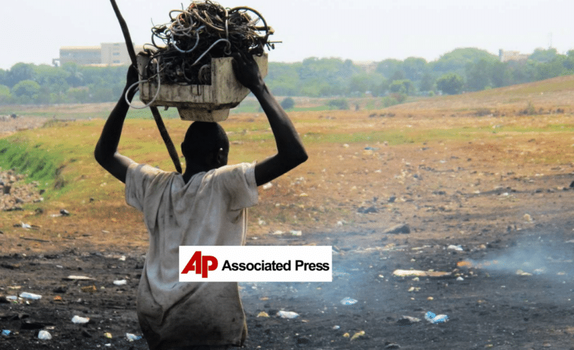 a man carrying trash over his head, AP logo in the foreground