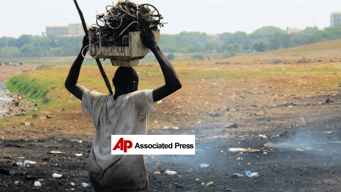 a man carrying trash over his head, AP logo in the foreground