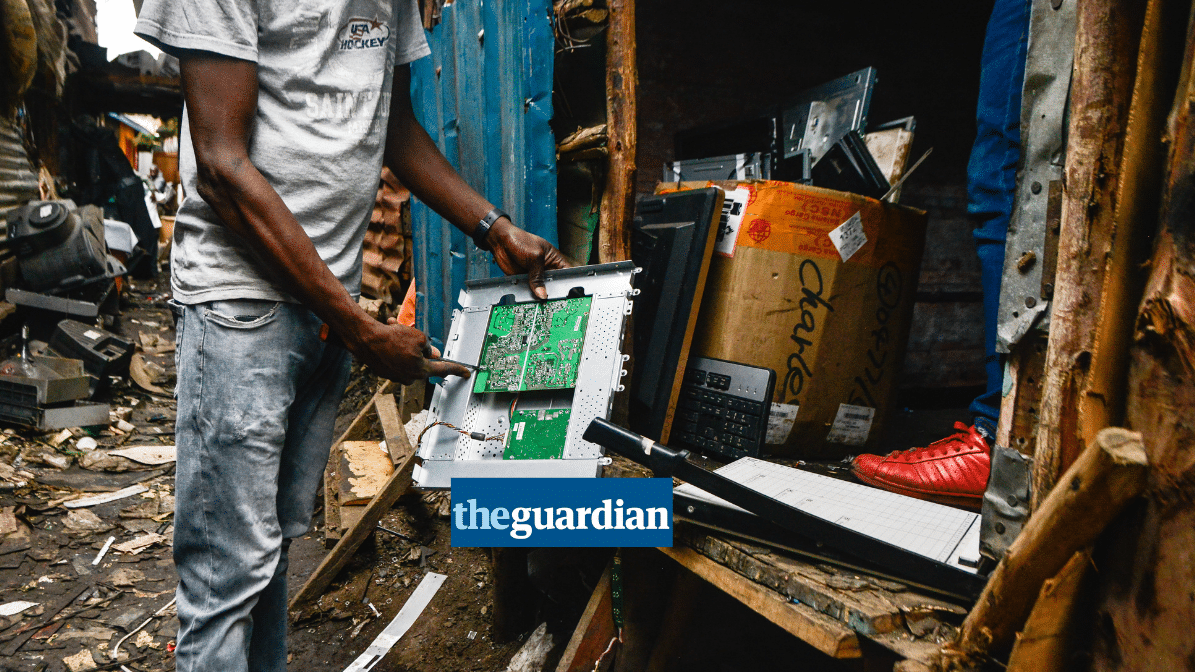 a waste picker holding a piece of plastic e-waste, Guardian logo in the foreground