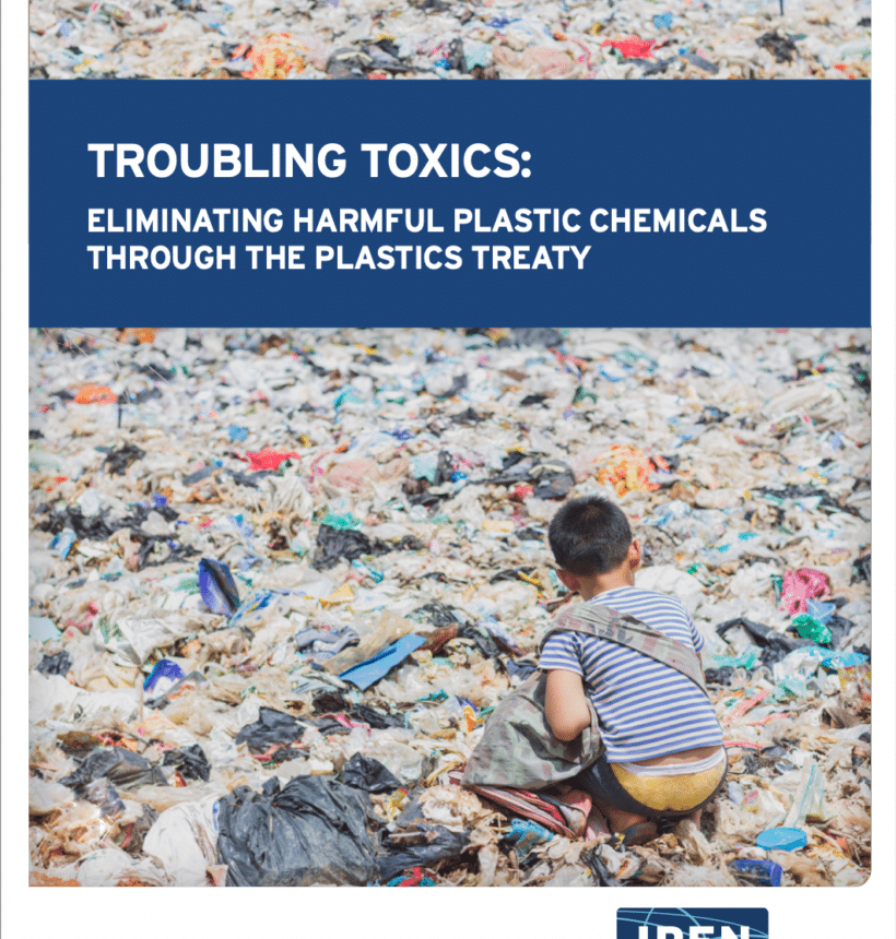 young child waste picking in a large field of plastic trash