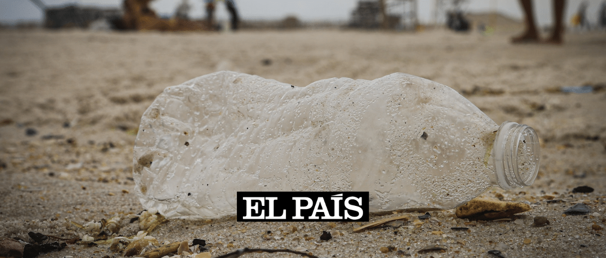 a dirty plastic bottle on a beach
