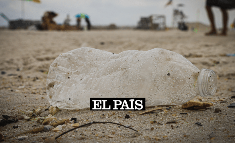 a dirty plastic bottle on a beach