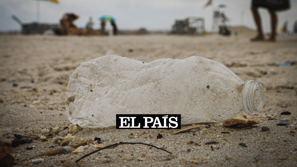 a dirty plastic bottle on a beach
