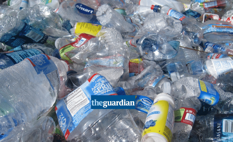 a large pile of plastic bottles, Guardian logo in foreground