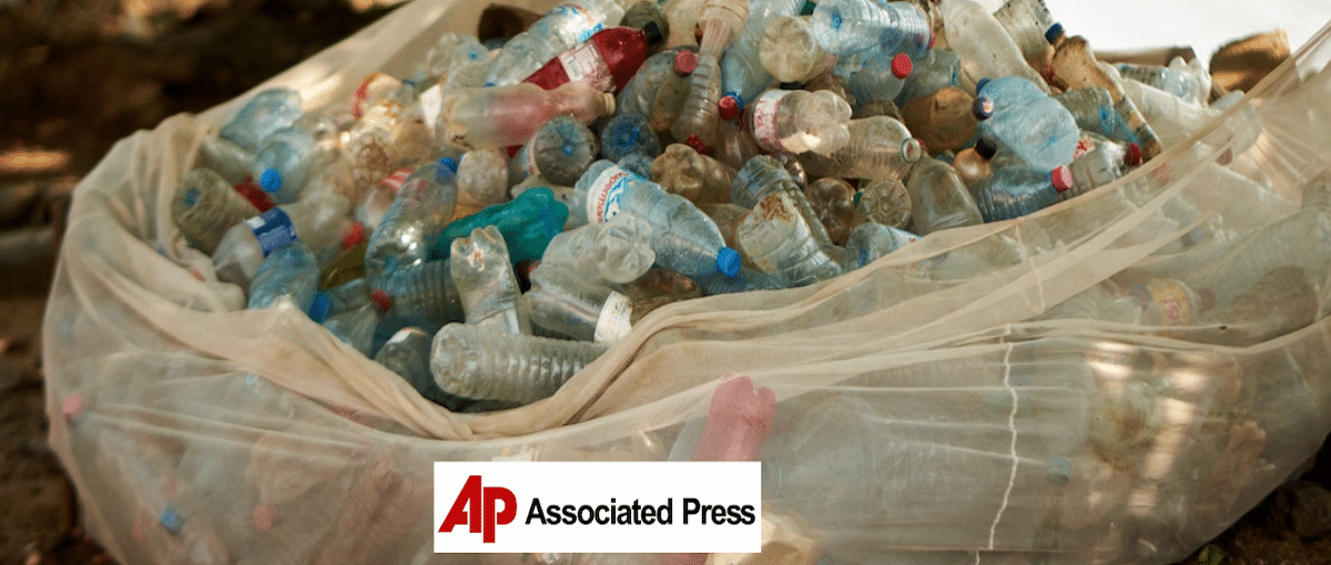 a large bag of plastic bottles, AP logo in foreground