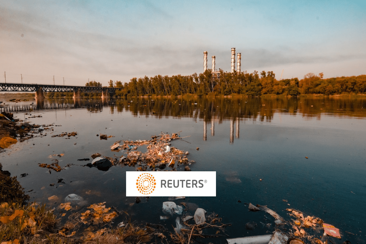 a pond with plastic trash, Reuters logo in foreground