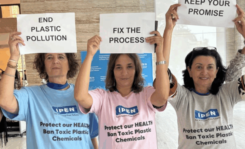 3 IPNers holding up signs at INC5.2